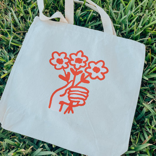 Holding Flowers Tote Bag